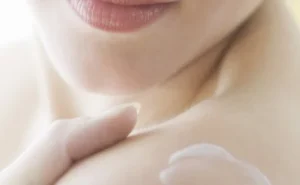 close-up of a woman's lips and a hand on her chest